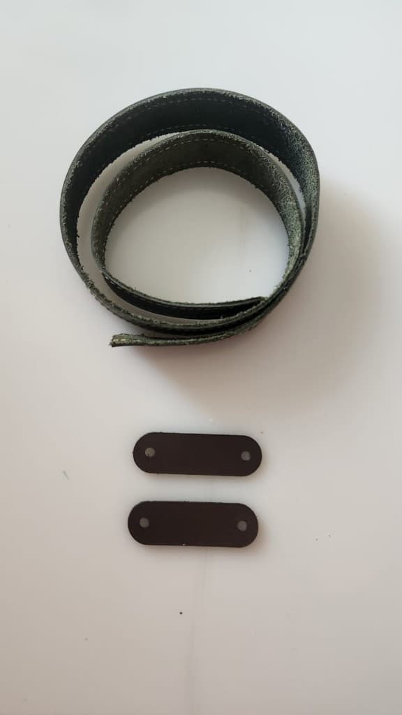 Dark leather shoulder strap with attachment tabs by Plaasjaap