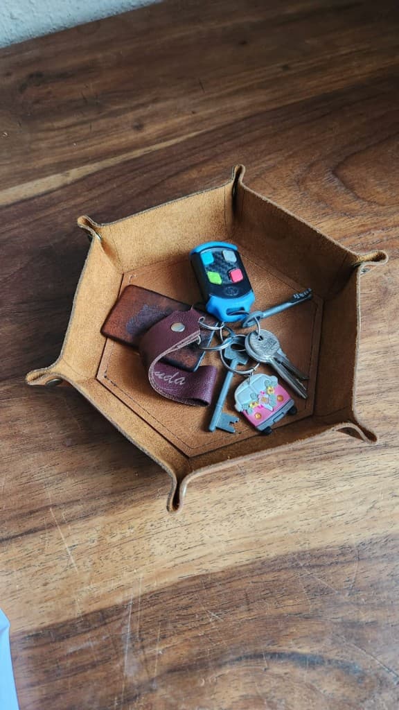 Handmade hexagonal leather key tray with keys by Plaasjaap
